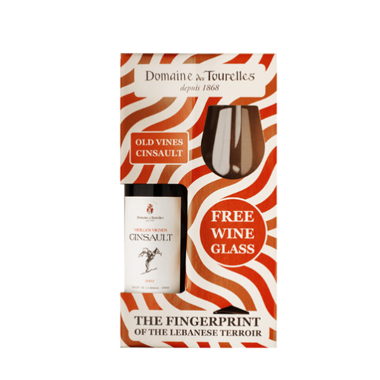 Wine bottle with packaging featuring a free wine glass offer, Domaine de Tourelles brand visible.